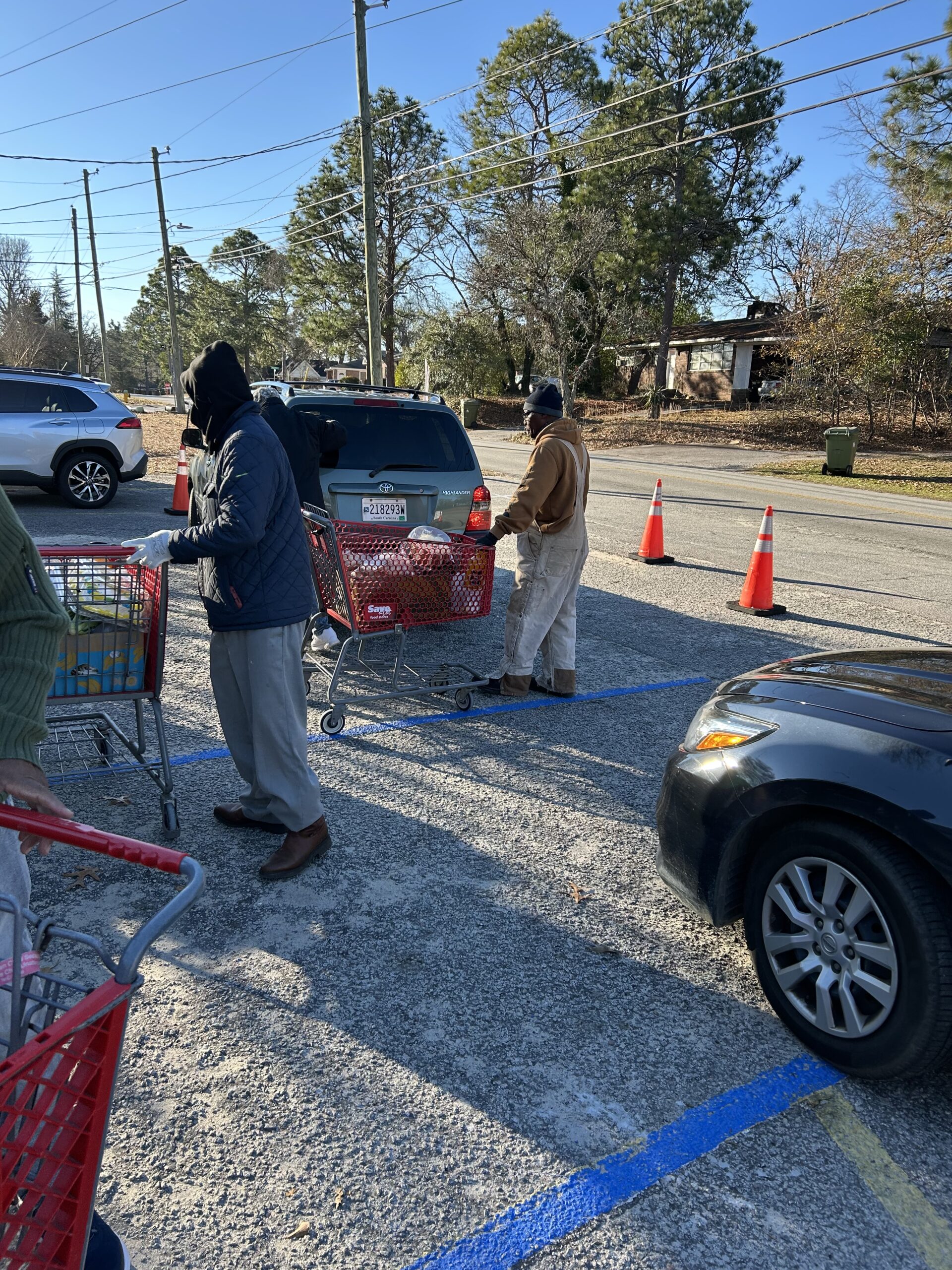 Volunteers giving food in the drive thru.